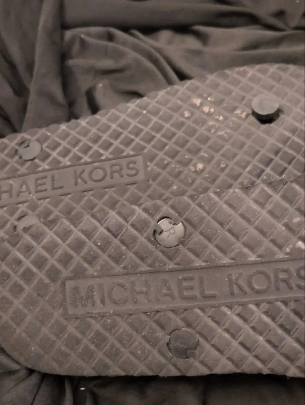 Michael Kors Black Logo Monogram Flip Flops with Silver MK Medallions.